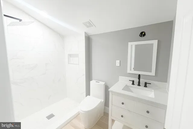 a bathroom with a bathtub shower sink and a toilet