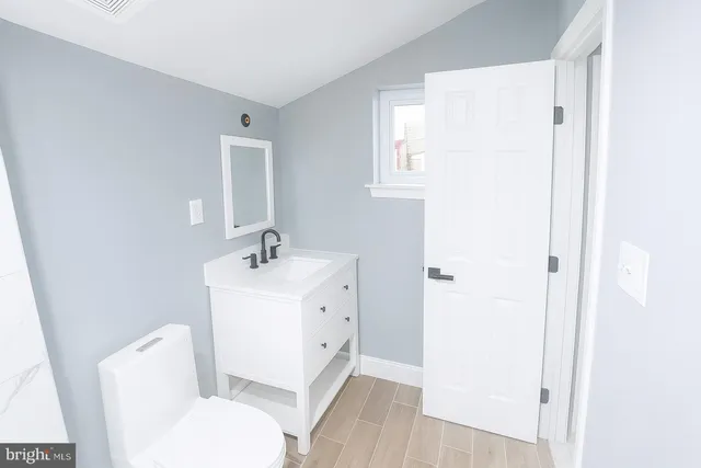 a white toilet sitting next to a bathroom sink