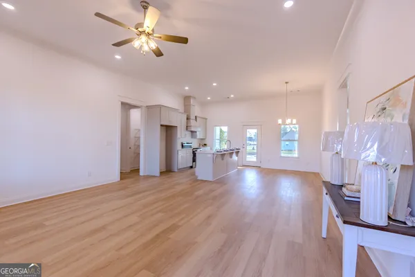 a kitchen with granite countertop white cabinets and stainless steel appliances