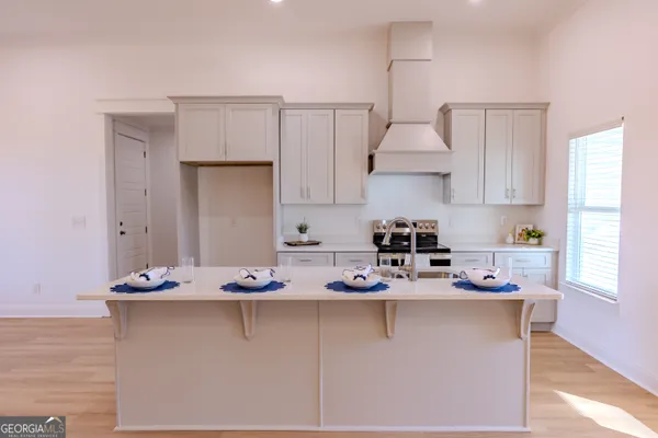 a view of a small space with wooden floor and a window