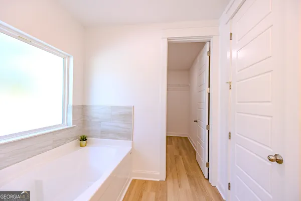 a view of a hallway with wooden floor