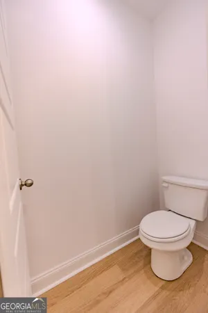a bathroom with a sink a toilet a mirror and vanity