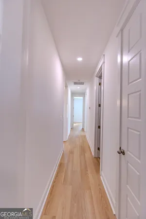 a view of a room with wooden floor and a sink