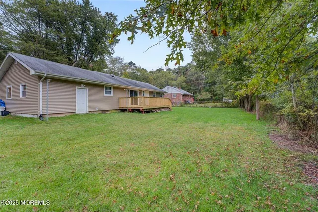a view of house with backyard
