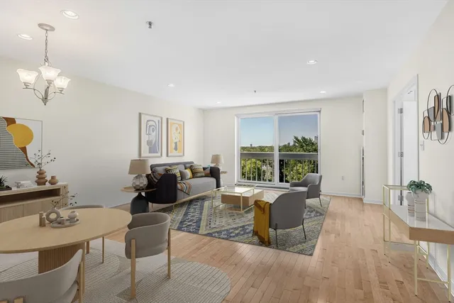 a living room with furniture two window and a table