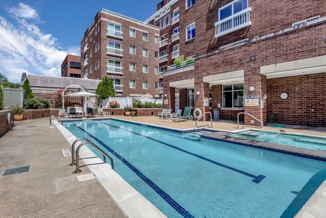 a view of a building with sitting area and furniture