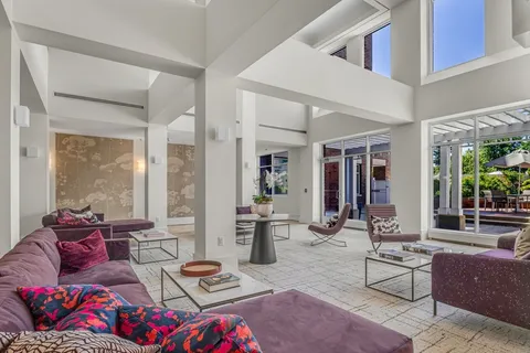 a living room with furniture and view of kitchen