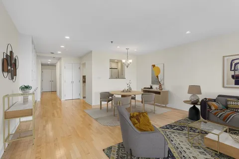 a living room with furniture a rug and a table