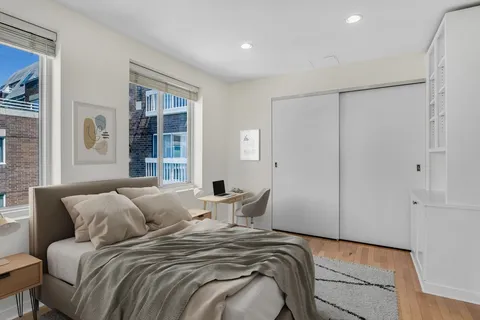 a bedroom with a large bed and a window