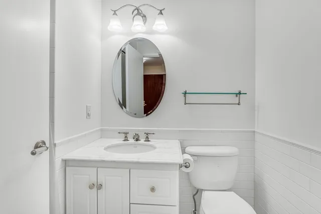 a bathroom with a toilet sink and mirror