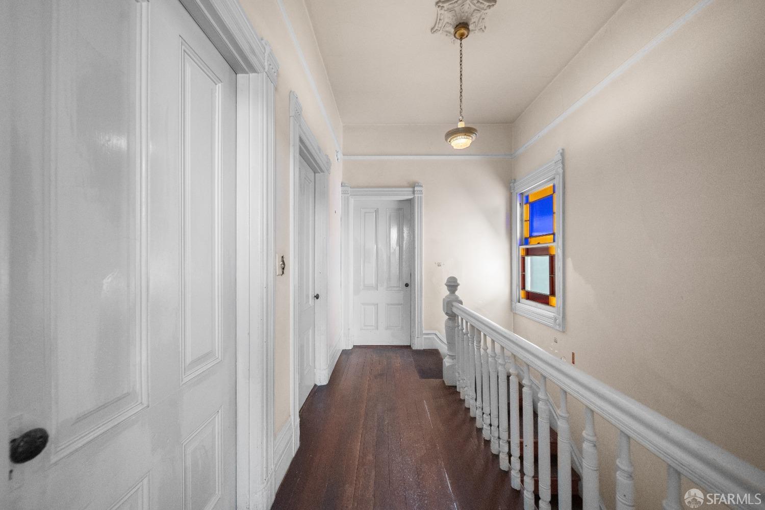 705 Jackson Street Oakland, CA 94607 - Photo 20 of 40 a view of a hallway with wooden floor and stairs
