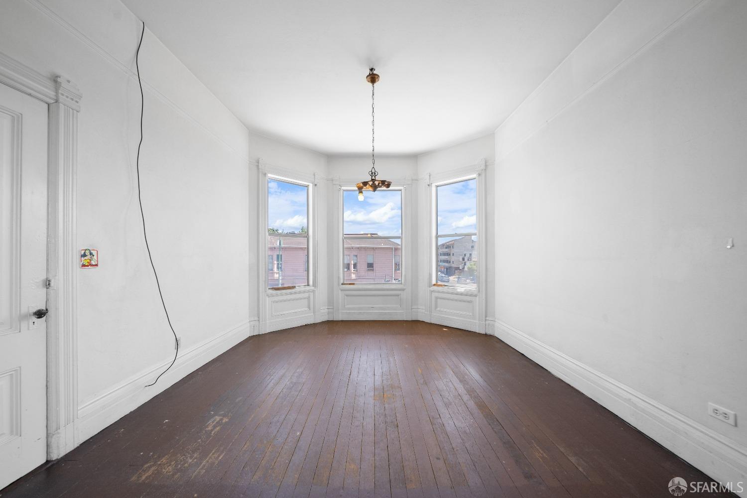 705 Jackson Street Oakland, CA 94607 - Photo 21 of 40 a view of an empty room with window and wooden floor
