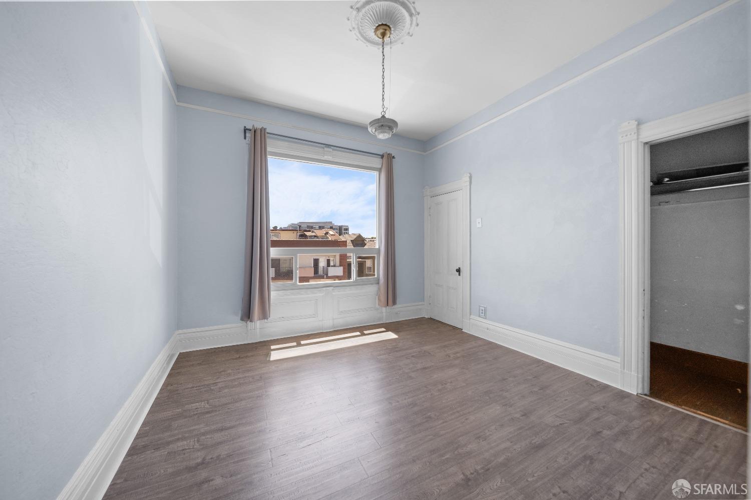 705 Jackson Street Oakland, CA 94607 - Photo 28 of 40 a view of livingroom with hardwood floor and window