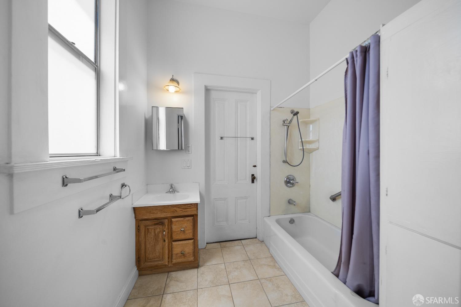 705 Jackson Street Oakland, CA 94607 - Photo 31 of 40 a bathroom with a tub sink and a mirror
