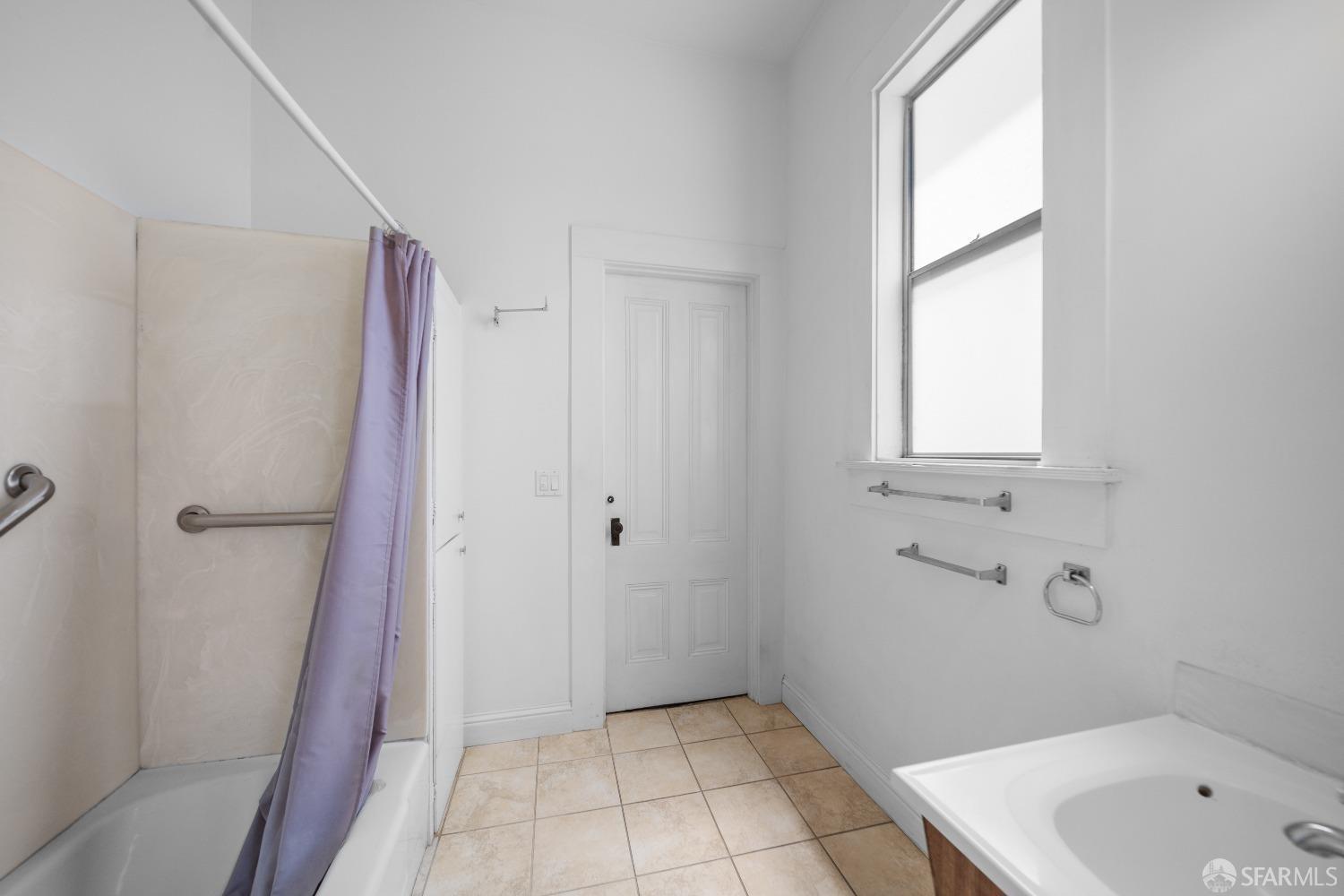 705 Jackson Street Oakland, CA 94607 - Photo 32 of 40 a bathroom with a sink a toilet and shower