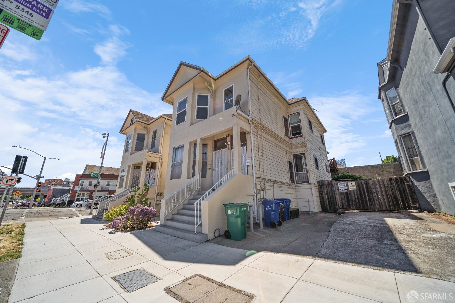 705 Jackson Street Oakland, CA 94607 - Photo 9 of 40 a view of a white house with iron fence