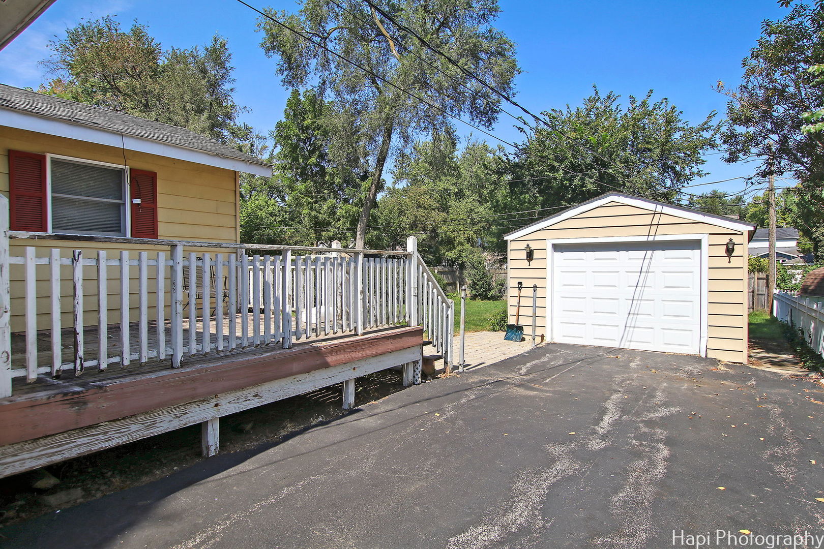 4906 Maple Hill Drive McCullom Lake, IL 60050 - Photo 20 of 23 a view of a house with a small yard and wooden fence
