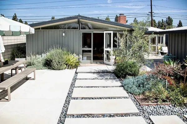 a front view of a house with outdoor seating