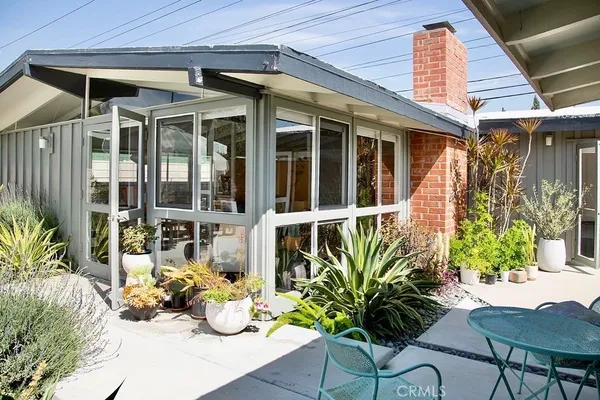 a view of outdoor dining space with a patio and plants