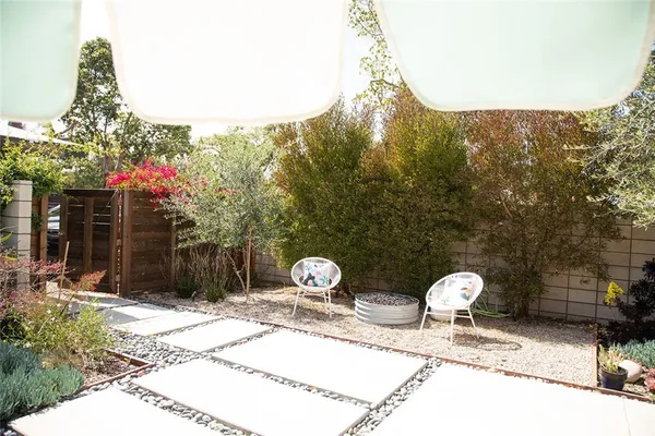 a living room with large windows and a table