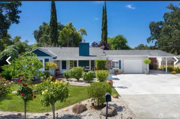 a front view of a house with a garden