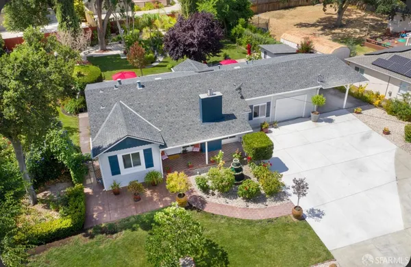 an aerial view of a house with a yard and potted plants