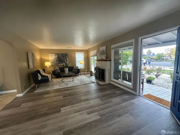 a view of a livingroom with furniture water view and wooden floor