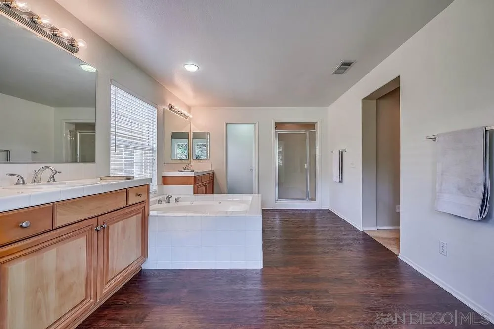 33391 Manchester Road Temecula, CA 92592 - Photo 14 of 32 a large bathroom with a double vanity sink and a mirror