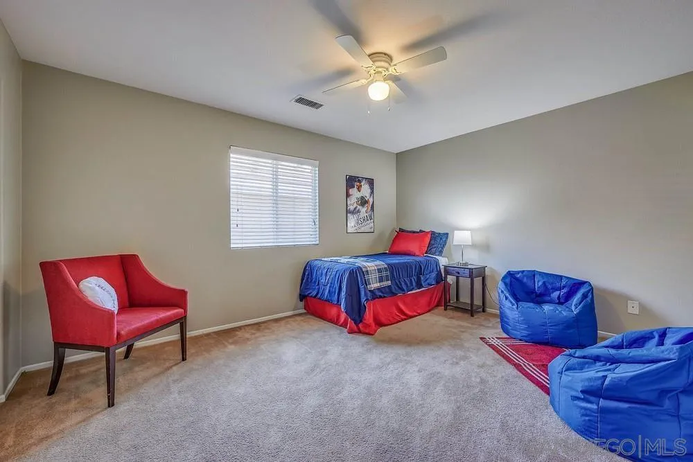 33391 Manchester Road Temecula, CA 92592 - Photo 20 of 32 a bedroom with a bed and a chair