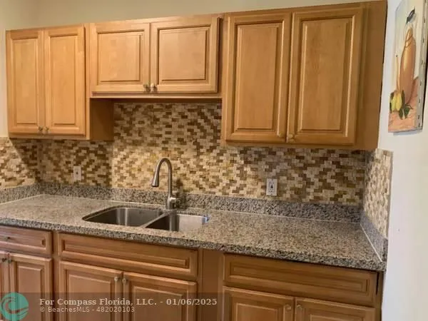 a kitchen with granite countertop a sink and a granite counter tops