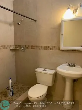 a bathroom with a toilet a sink and mirror