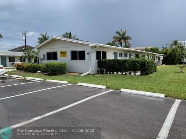 120 Northeast 10th Avenue, Unit 1 Hallandale Beach, FL 33009 - Photo 3 of 18 a front view of a house with a yard