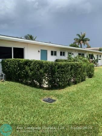120 Northeast 10th Avenue, Unit 1 Hallandale Beach, FL 33009 - Photo 7 of 18 a front view of a house with garden