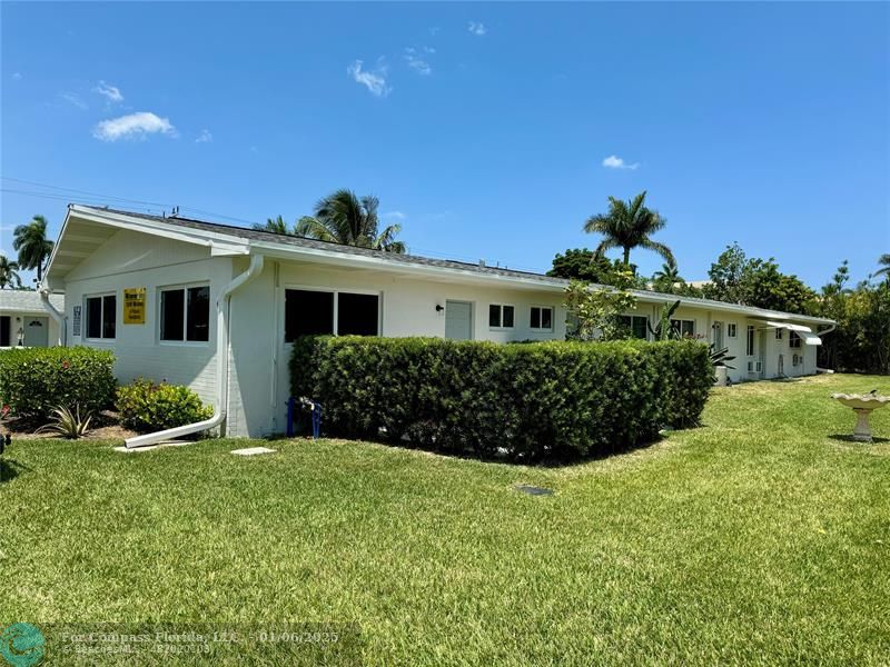 120 Northeast 10th Avenue, Unit 1 Hallandale Beach, FL 33009 - Photo 8 of 18 a front view of a house with a yard