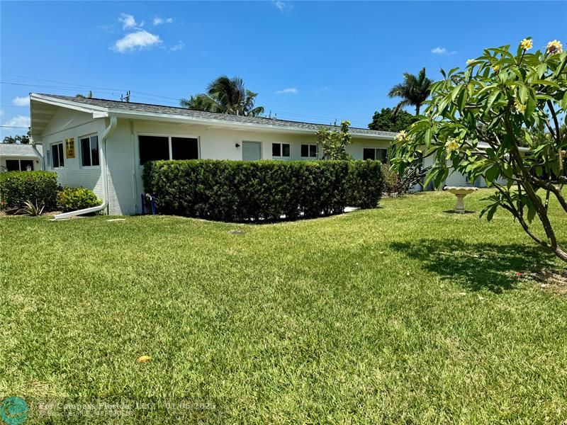 120 Northeast 10th Avenue, Unit 1 Hallandale Beach, FL 33009 - Photo 9 of 18 a view of a house with a yard