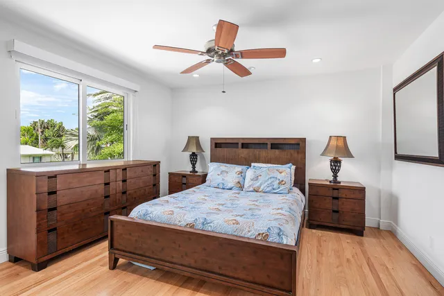 a bathroom with a sink a toilet a mirror and shower