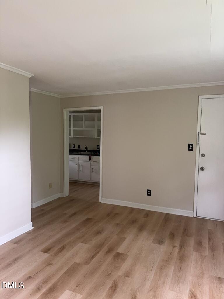 703 Daniels Street, Unit C Raleigh, NC 27605 - Photo 4 of 8 wooden floor in an empty room