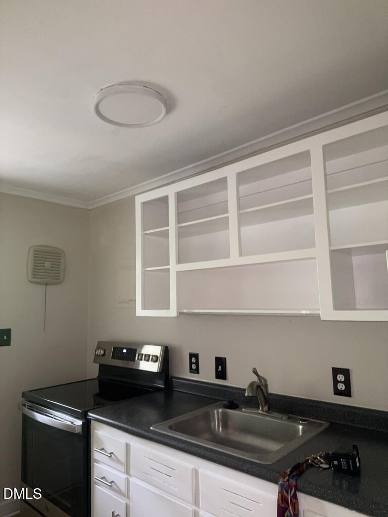 703 Daniels Street, Unit C Raleigh, NC 27605 - Photo 5 of 8 a kitchen with a sink and cabinets
