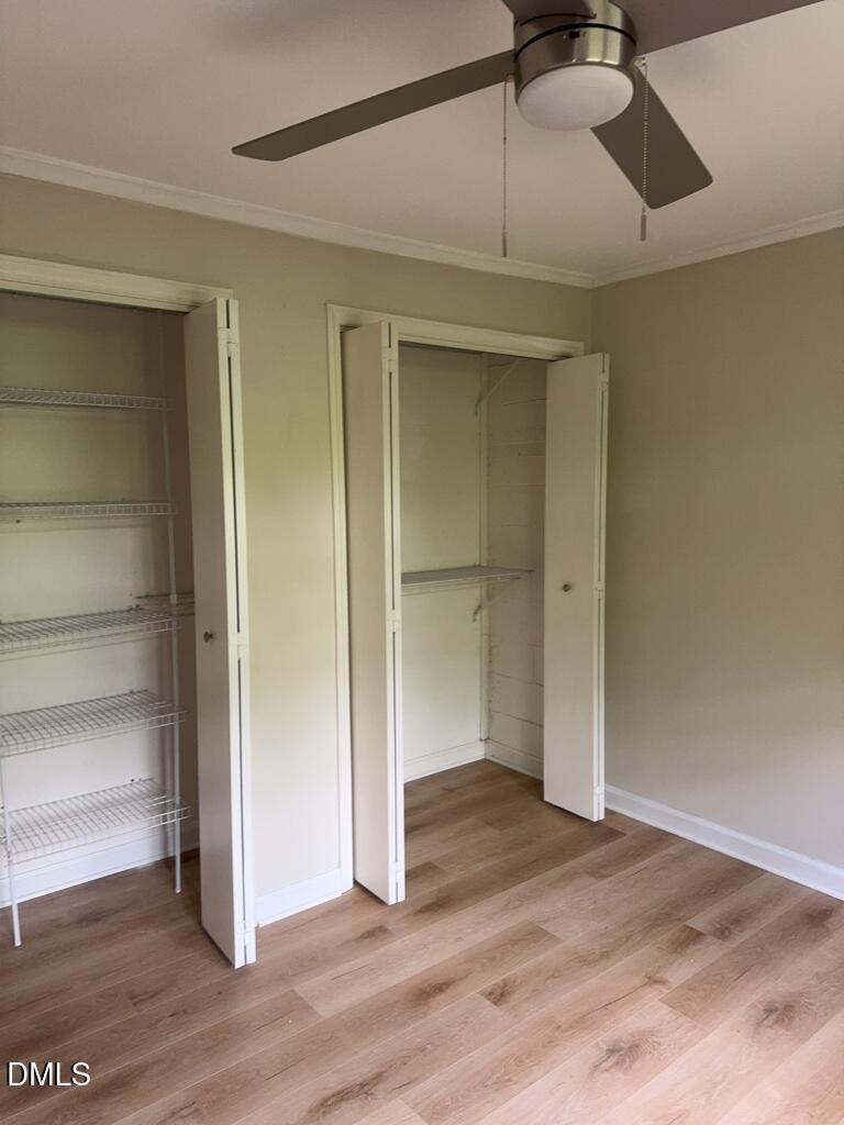 703 Daniels Street, Unit C Raleigh, NC 27605 - Photo 7 of 8 a view of an empty room and wooden floor closet area