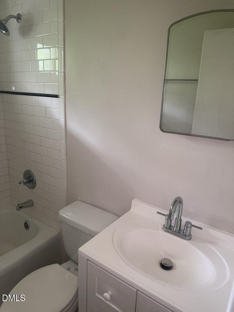 703 Daniels Street, Unit C Raleigh, NC 27605 - Photo 8 of 8 a bathroom with a sink a toilet and shower