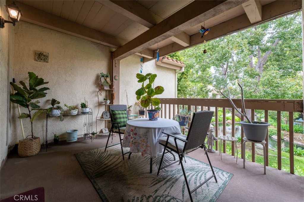 a view of a porch with furniture and a yard
