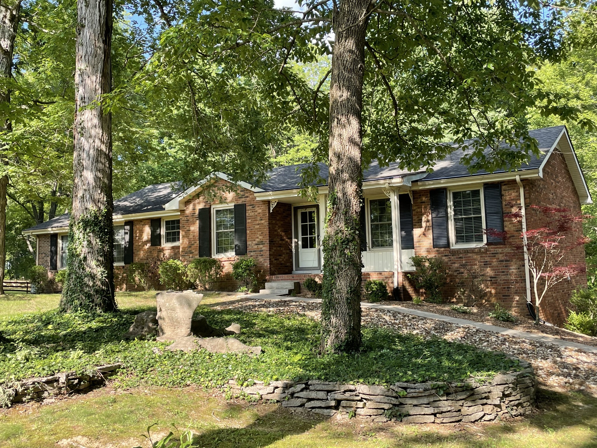 a front view of a house with garden
