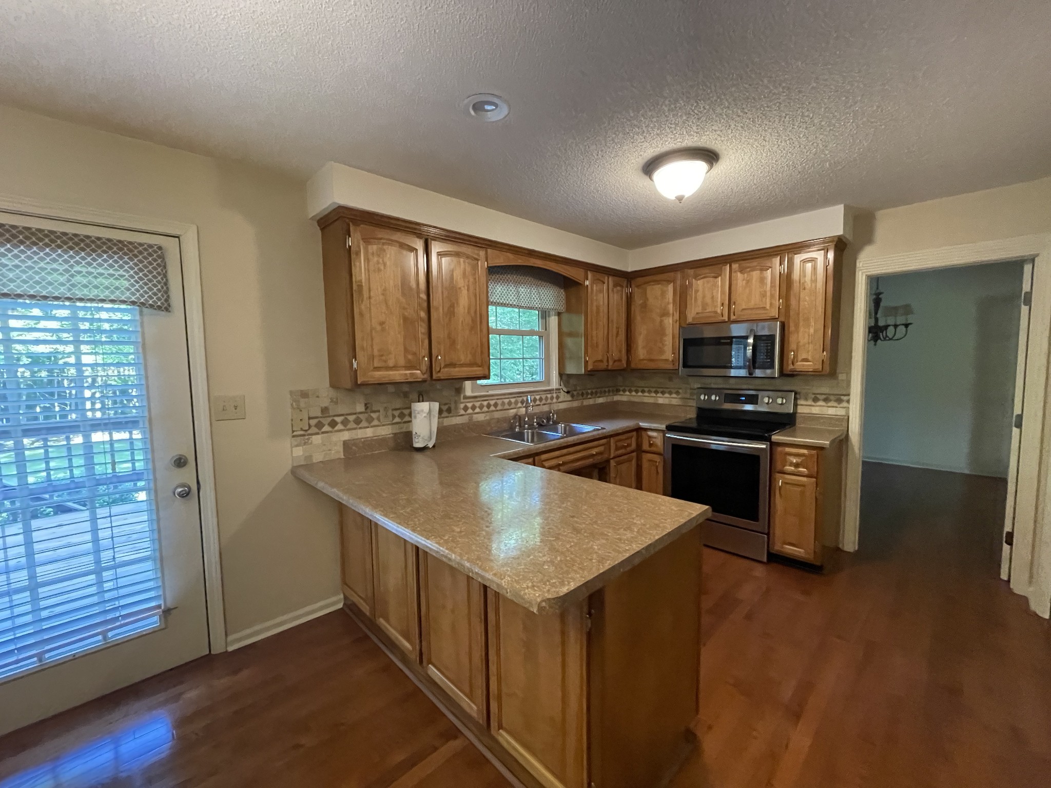 1224 Poplar Ridge Road Chapmansboro, TN 37035 - Photo 19 of 40 a kitchen with stainless steel appliances granite countertop a sink stove and refrigerator