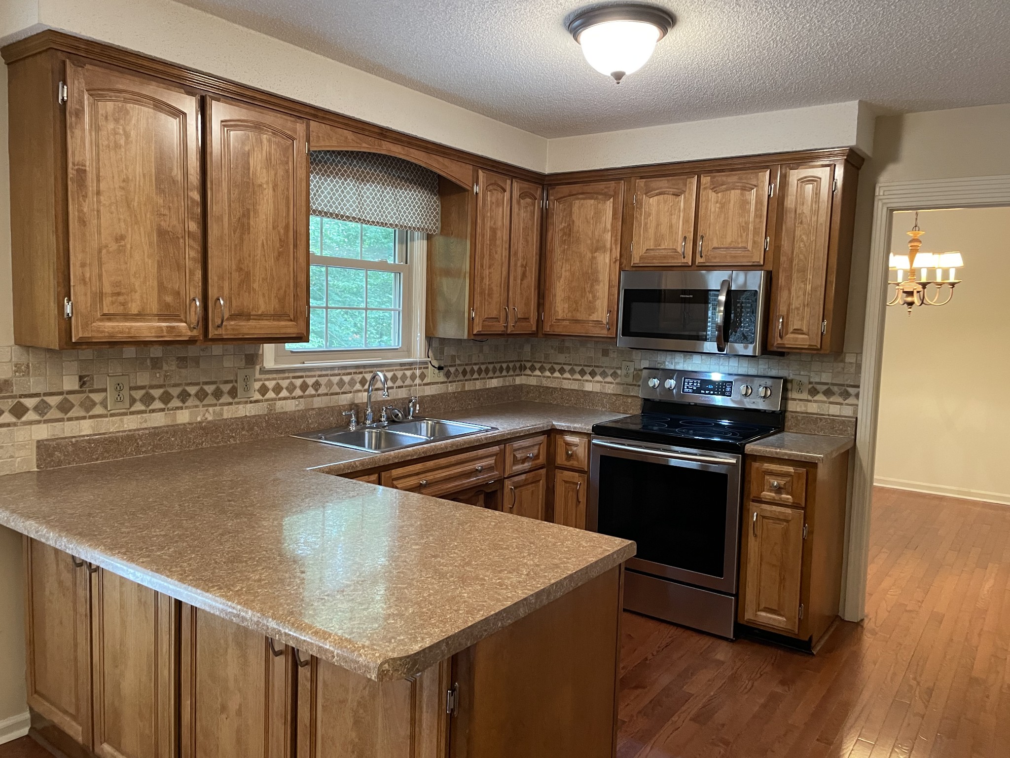 1224 Poplar Ridge Road Chapmansboro, TN 37035 - Photo 20 of 40 a kitchen with a stove a sink and a microwave