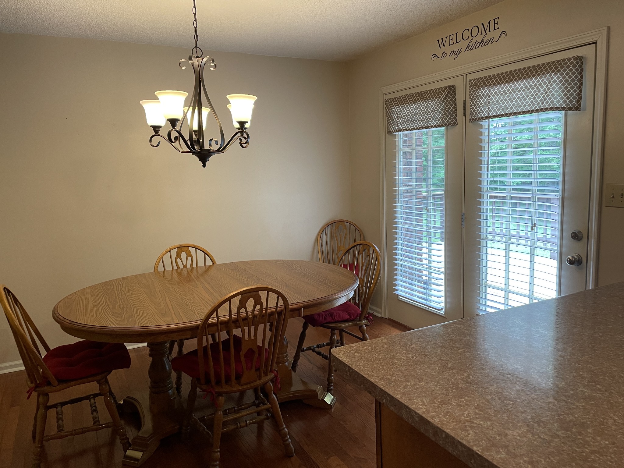 1224 Poplar Ridge Road Chapmansboro, TN 37035 - Photo 22 of 40 a view of a dining room with furniture wooden floor and chandelier