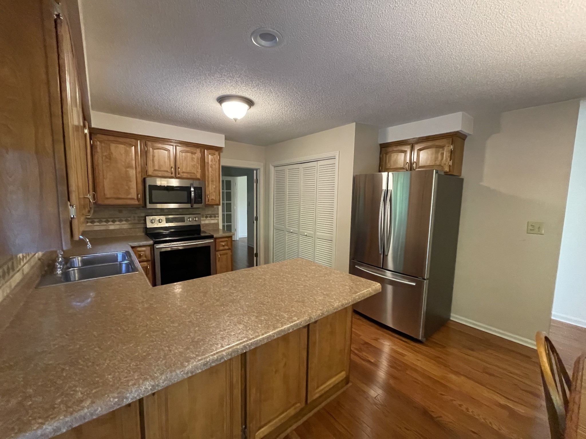 1224 Poplar Ridge Road Chapmansboro, TN 37035 - Photo 23 of 40 a kitchen with stainless steel appliances a refrigerator and stove