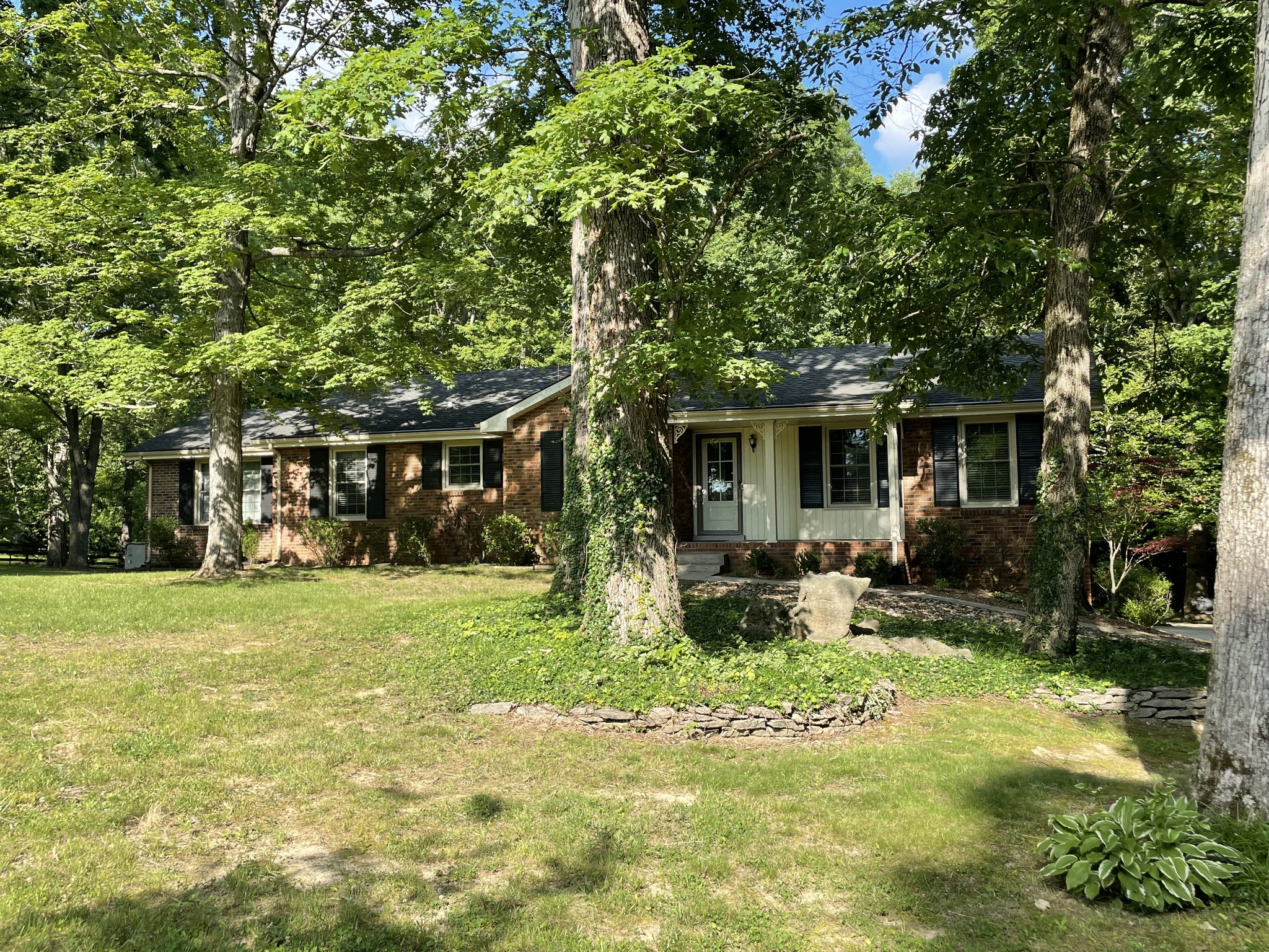 1224 Poplar Ridge Road Chapmansboro, TN 37035 - Photo 3 of 40 a front view of house with a garden and patio