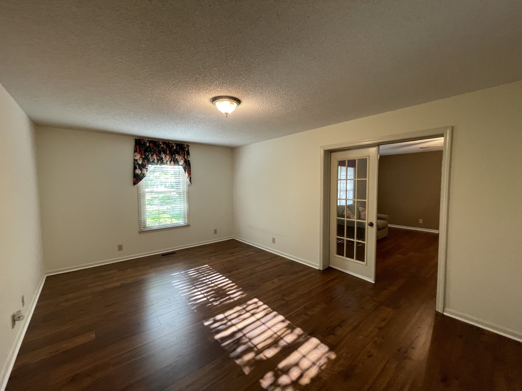 1224 Poplar Ridge Road Chapmansboro, TN 37035 - Photo 33 of 40 an empty room with wooden floor and windows