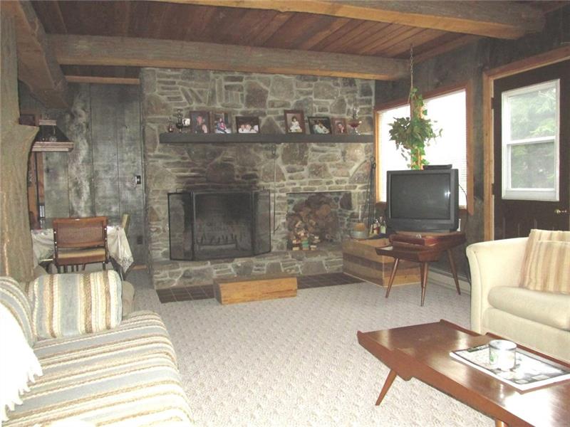 The fireplace is the focal point of the room! Door to the right used to walk out to a deck. 