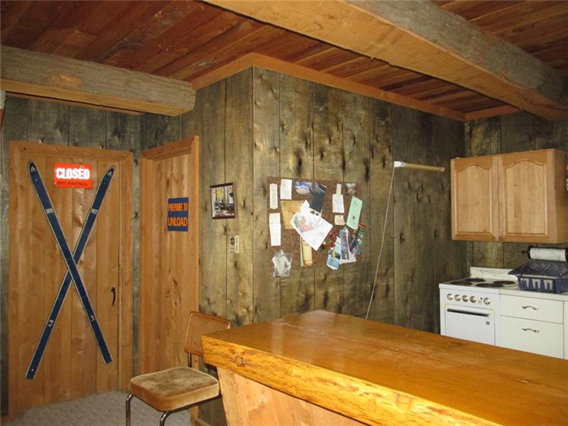 The door with the skis lead into a bedroom. The half bath is to the right.